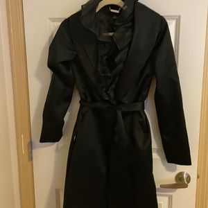 White House Black Market black trench coat with neck ruffle.